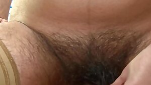 Sexy Riani fingers her hairy pussy on the desk