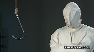 Dude in straight jacket ass plugged in bdsm. Immobilized male slave in straight jacket and hood over his head gets ass spanked and plugged with metal hook then gets cock weighted with block in dungeon by mistress Jasmine
